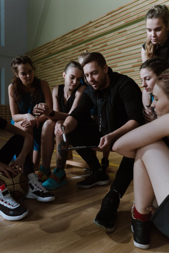 A Man Coaching a Team of Women